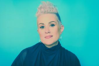 portrait image of singer Katie Noonan, with teal background