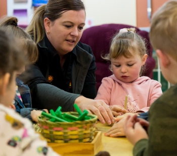 Teacher playing with children