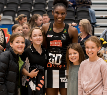 Happy kids with star netballer