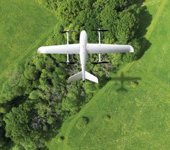 Plane flying over green fields