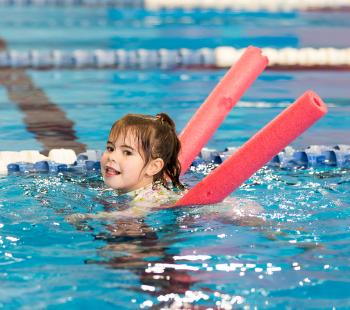 Child on pool noodle
