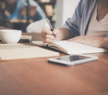 Woman writing on paper