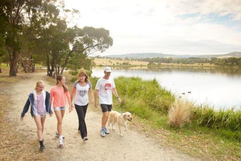 A family walking around a lake in Churchill.