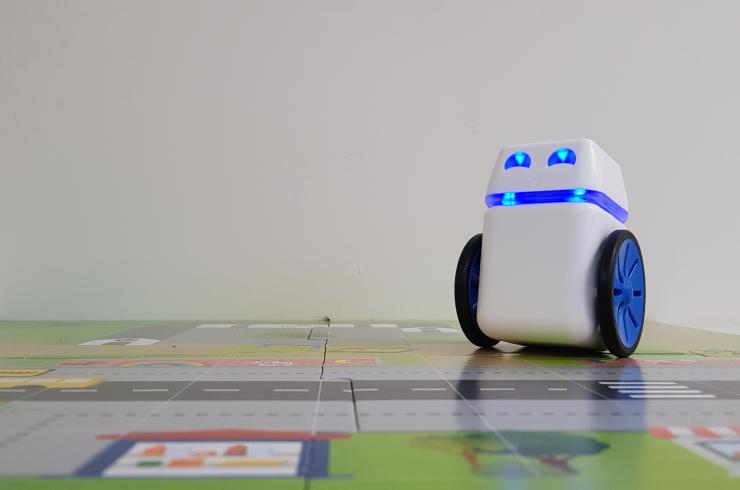 Small blue and white robot on a map grid