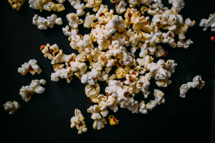 Image of popcorn scattered on a black surface