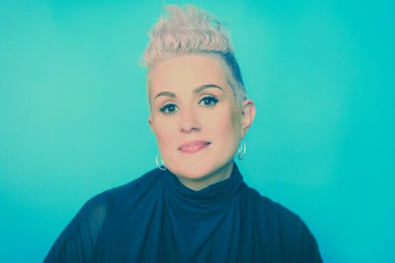 portrait image of singer Katie Noonan, with teal background