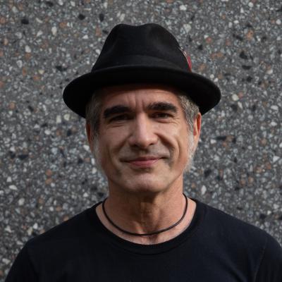 Man wearing black t-shirt and black felt cap
